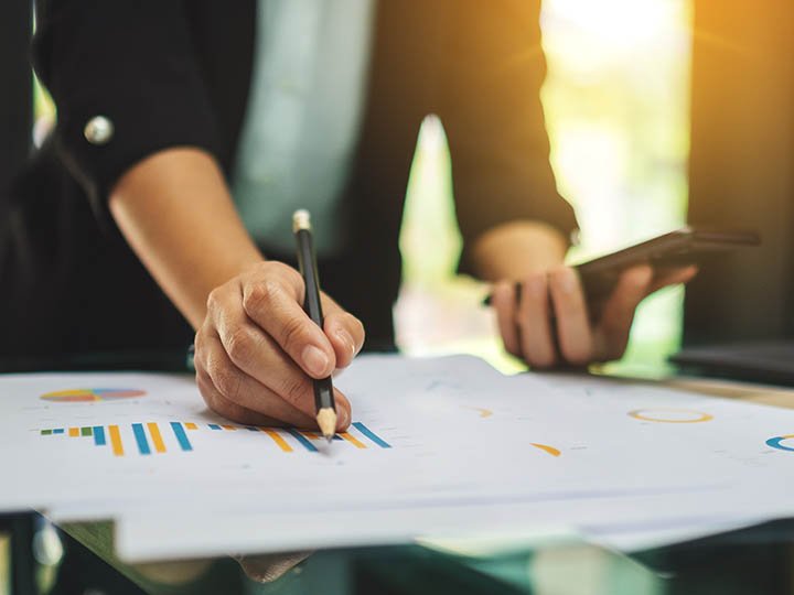 A businesswoman writing and working on business financial data a Accounts Receivables