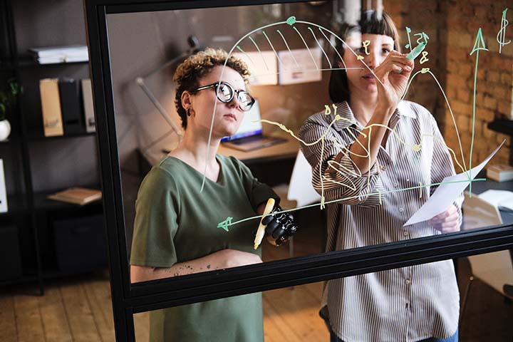 Analysts analyzing financial charts in office Financial Department Evaluation