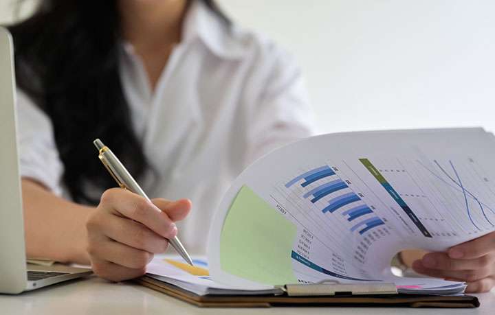 Business woman checking company performance report. Monthly Reporting